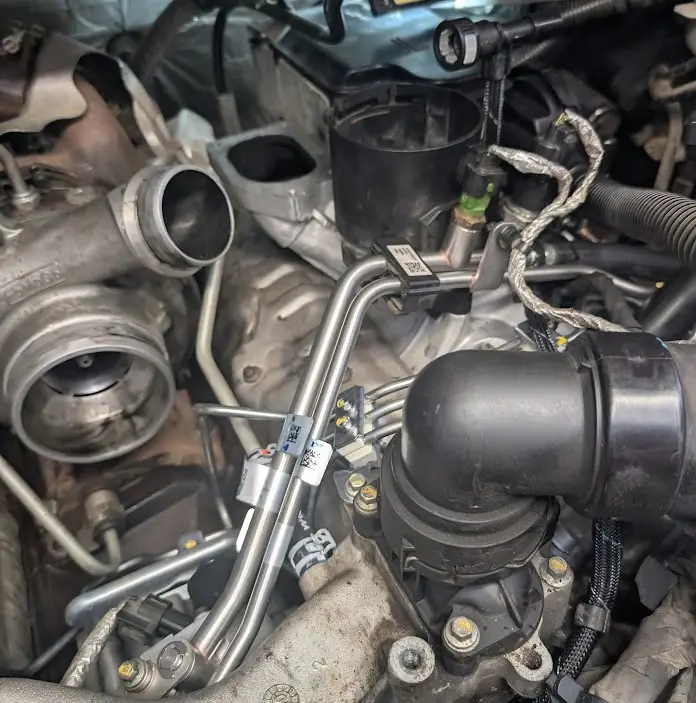 Angle view of a 2020 Chevy Colorado on a lift with transmission pan exposed, highlighting torque converter shudder diagnostic area.