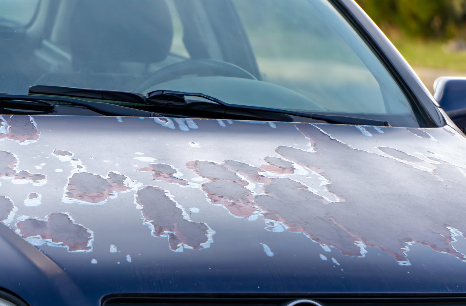 Subaru driver's door with window stuck halfway down, cleaning rubber channel with microfiber cloth