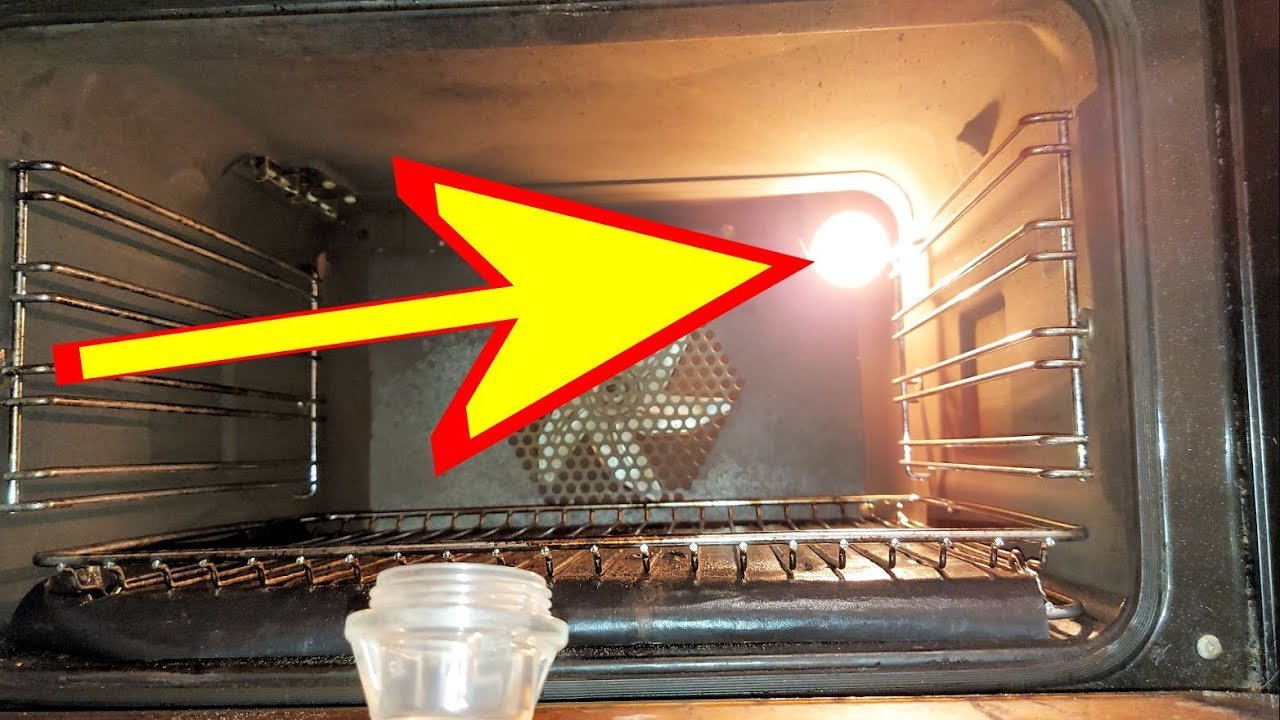 Person resetting the main circuit breaker to troubleshoot an oven light issue.