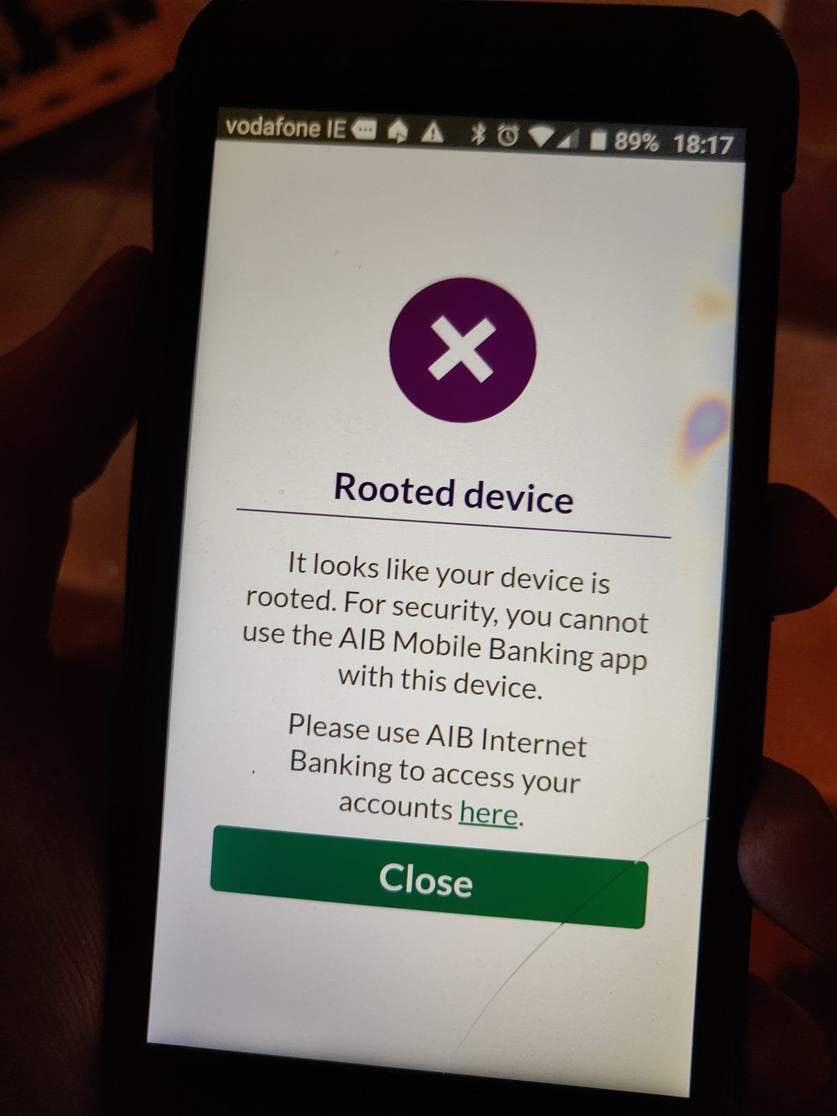 A person reviewing banking help resources on a smartphone at a desk.