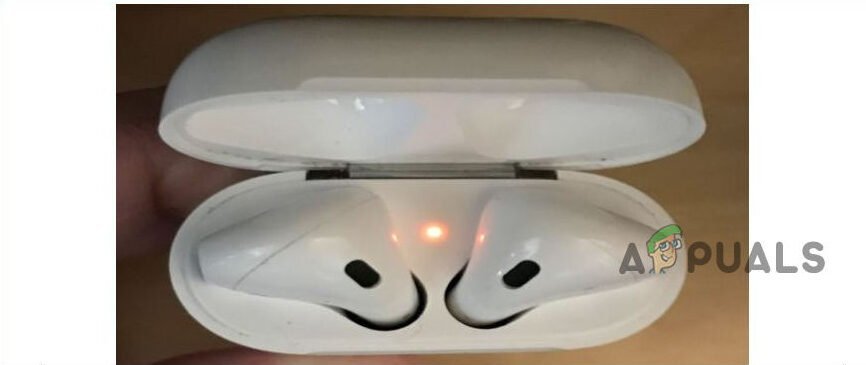 A wireless charging case with a solid amber light connected to a cable.
