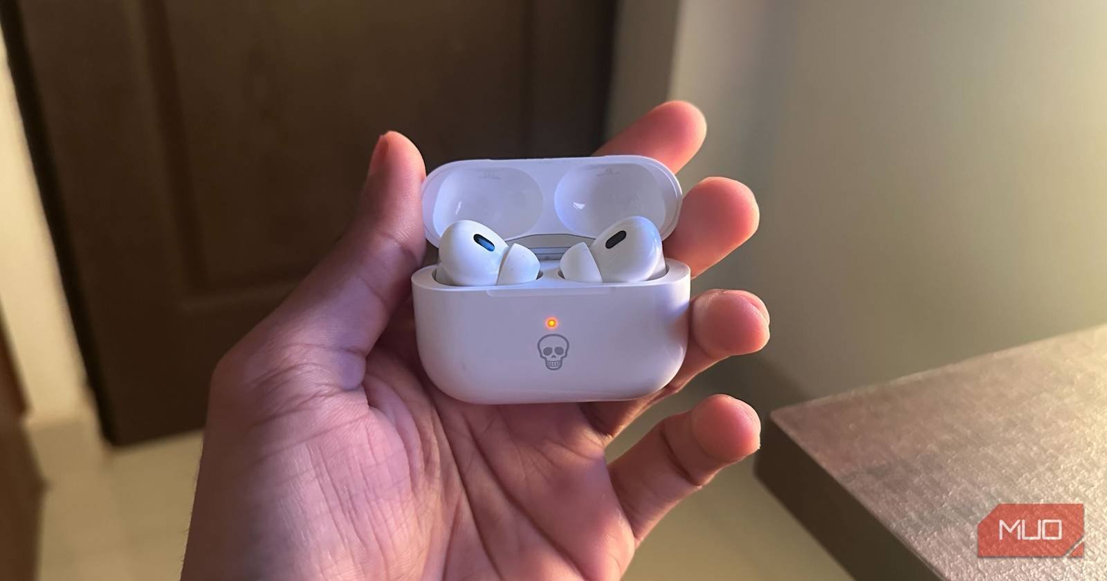 Cleaning the metal contacts inside the charging case to fix battery connection issues.