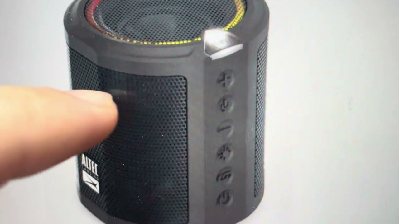 A portable speaker placed next to a tablet displaying technical troubleshooting information.