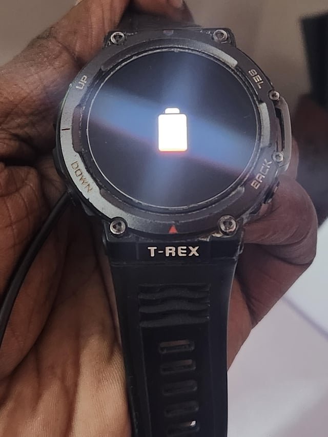 Performing a forced restart on an Amazfit smartwatch by holding the side button.