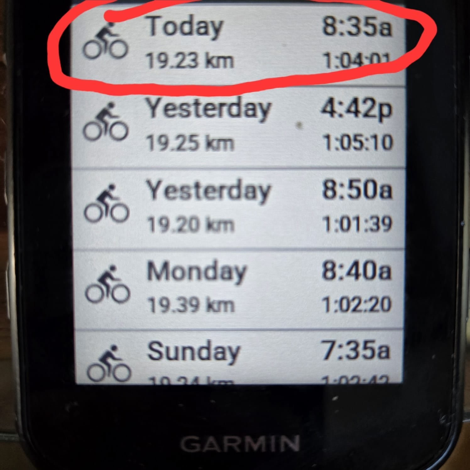A Garmin Edge 840 connected to a laptop via USB for file management.