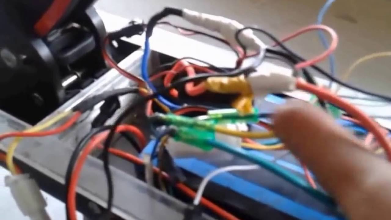Precision repair tools and a multimeter placed next to an electric scooter.