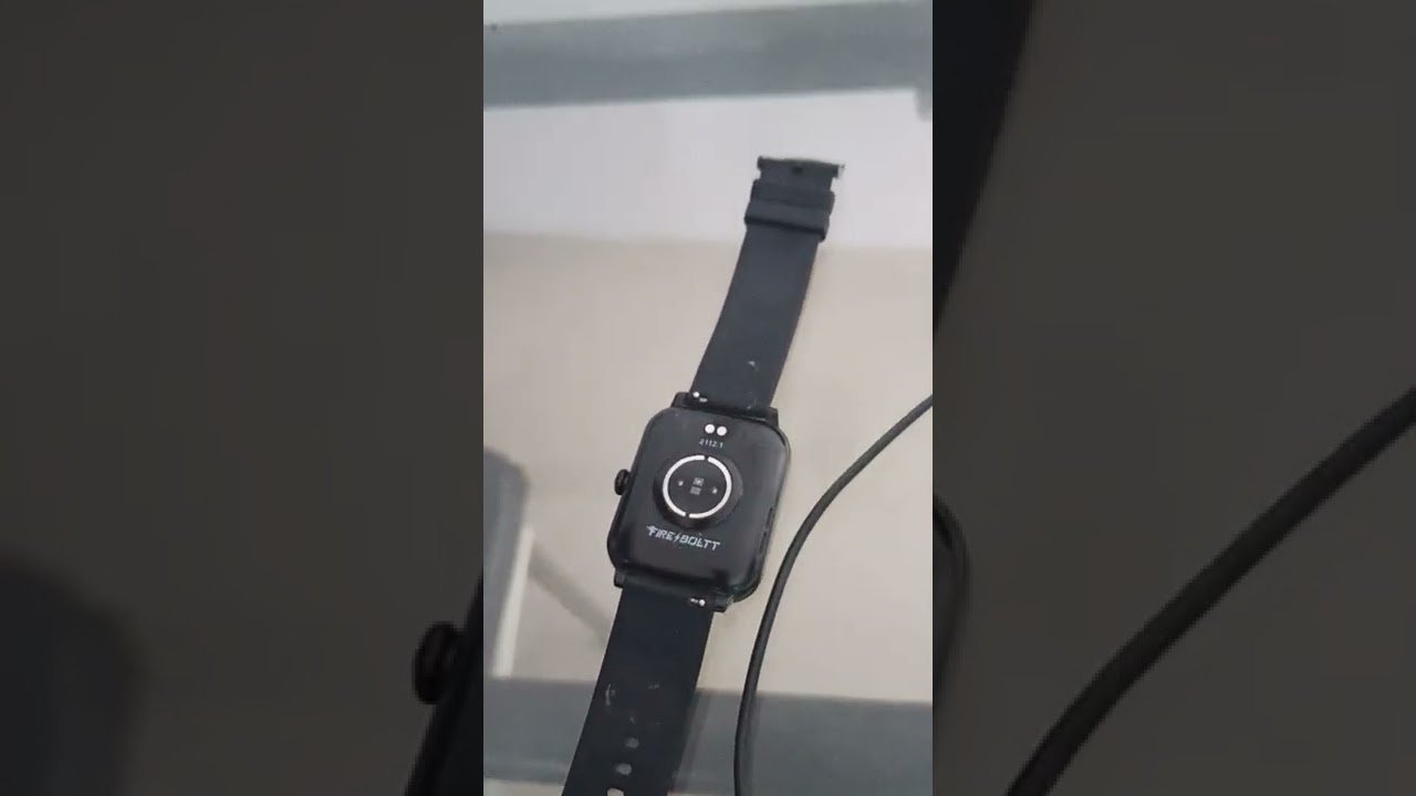 Macro view of smartwatch charging pins showing dust buildup and minor oxidation.