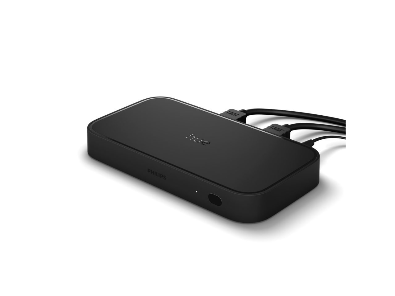 A person checking the HDMI cable connection on the back of a hue sync box.