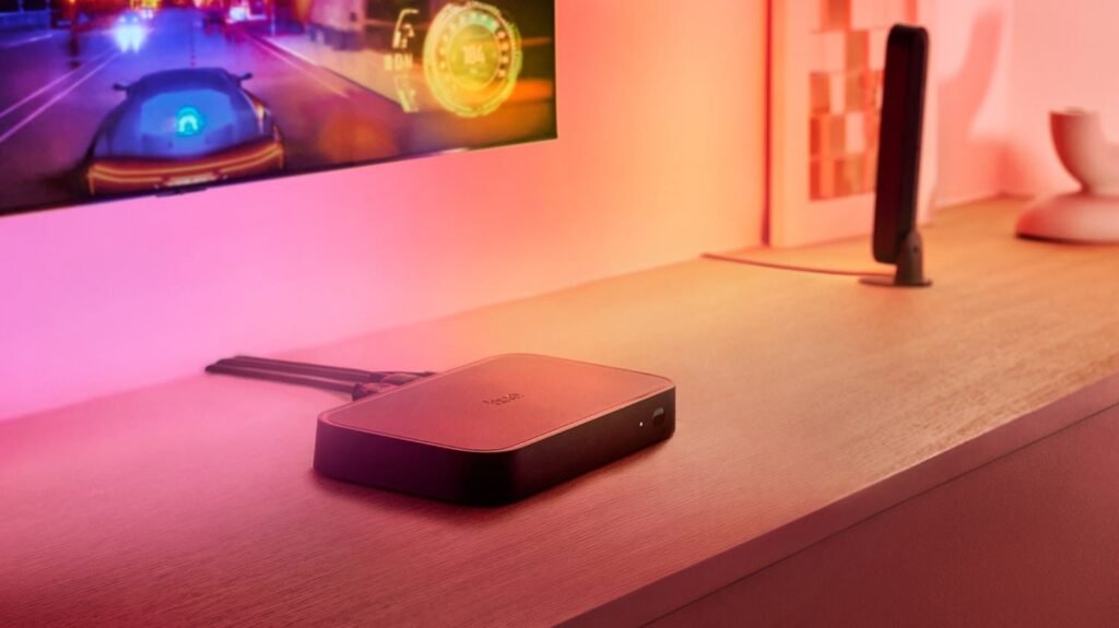 A modern home entertainment setup featuring a television with an active hue sync box.