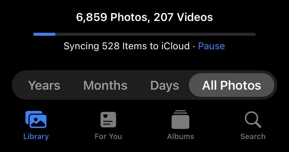 A person adjusting settings on an iPhone to fix photos not syncing to iCloud.