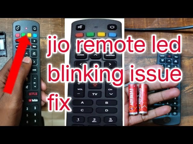 Close up of a remote control with a blinking red signal light.