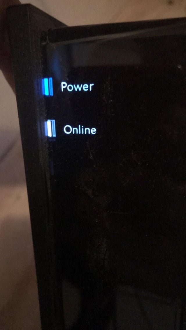 Close-up of a blue light blinking on a router indicating a network search.